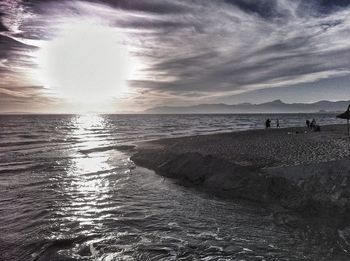 Scenic view of sea against cloudy sky