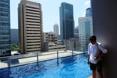 Mature woman standing by swimming pool