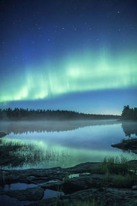 Scenic view of river against sky at night