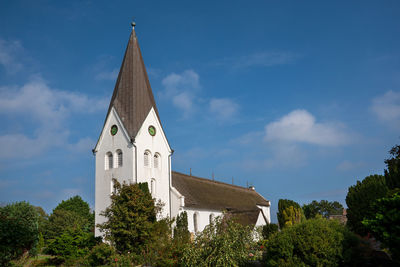 Old church of nebel against blue sky, amrum, germany