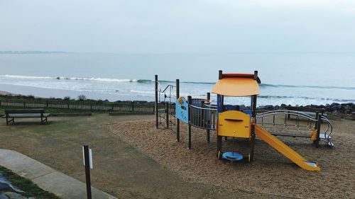 Lifeguard hut on beach against sky