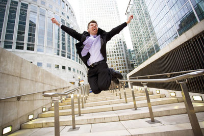 Full length of man jumping in city