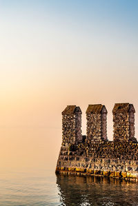 Scenic view of sea against clear sky during sunset