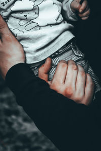 Midsection of woman holding hands