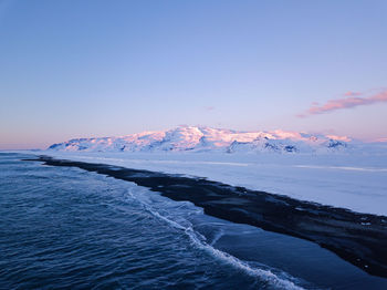 Scenic view of sea against sky during winter