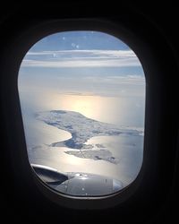 Aerial view of sea seen through airplane window