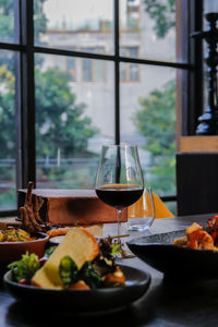 Close-up of meal and wine served on table