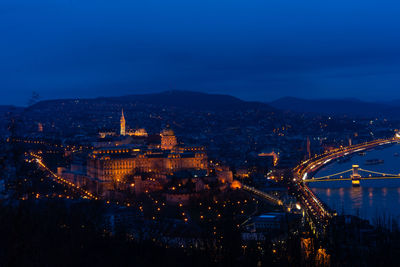 High angle view of illuminated buildings in city at night