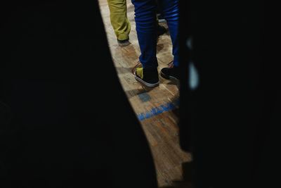 Low section of woman standing on tiled floor