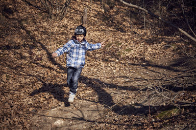 Full length of man standing in forest