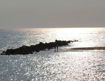 Scenic view of sea against clear sky during sunset