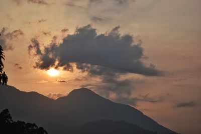 Low angle view of silhouette mountains against sky