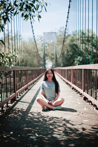 Portrait of woman on footbridge