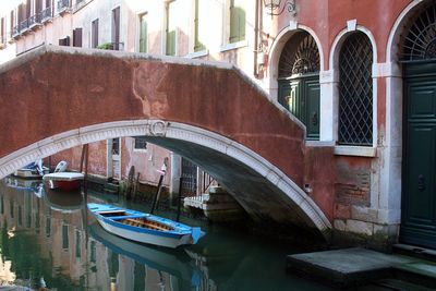 Venice - arch bridge over canal amidst buildings