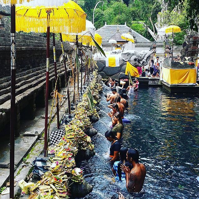 men, water, lifestyles, transportation, leisure activity, person, nautical vessel, mode of transport, large group of people, outdoors, high angle view, day, boat, river, yellow, nature, large group of objects