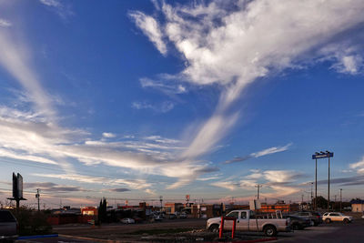Cars on road against blue sky