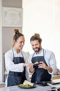 Man and woman standing on table