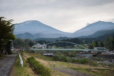Road by bridge against sky
