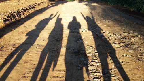 Shadow of people on road