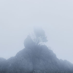 Scenic view of tree mountain against sky