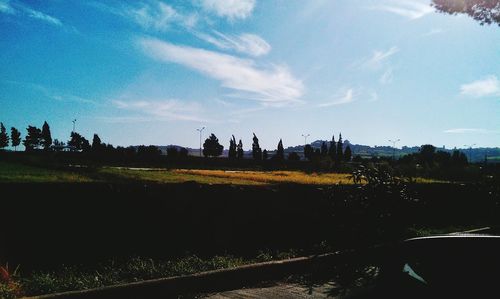 Scenic view of field against cloudy sky