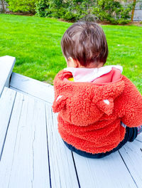 Rear view of boy with red umbrella