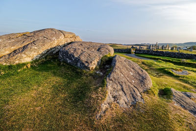 Scenic view of rocks on field against sky