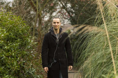 Portrait of smiling young man standing on land