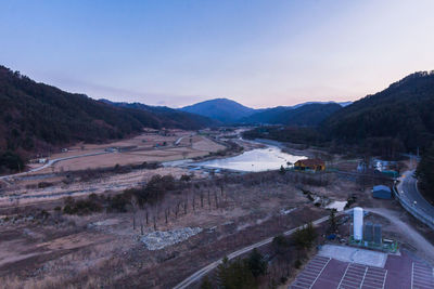 High angle view of road by mountains against sky