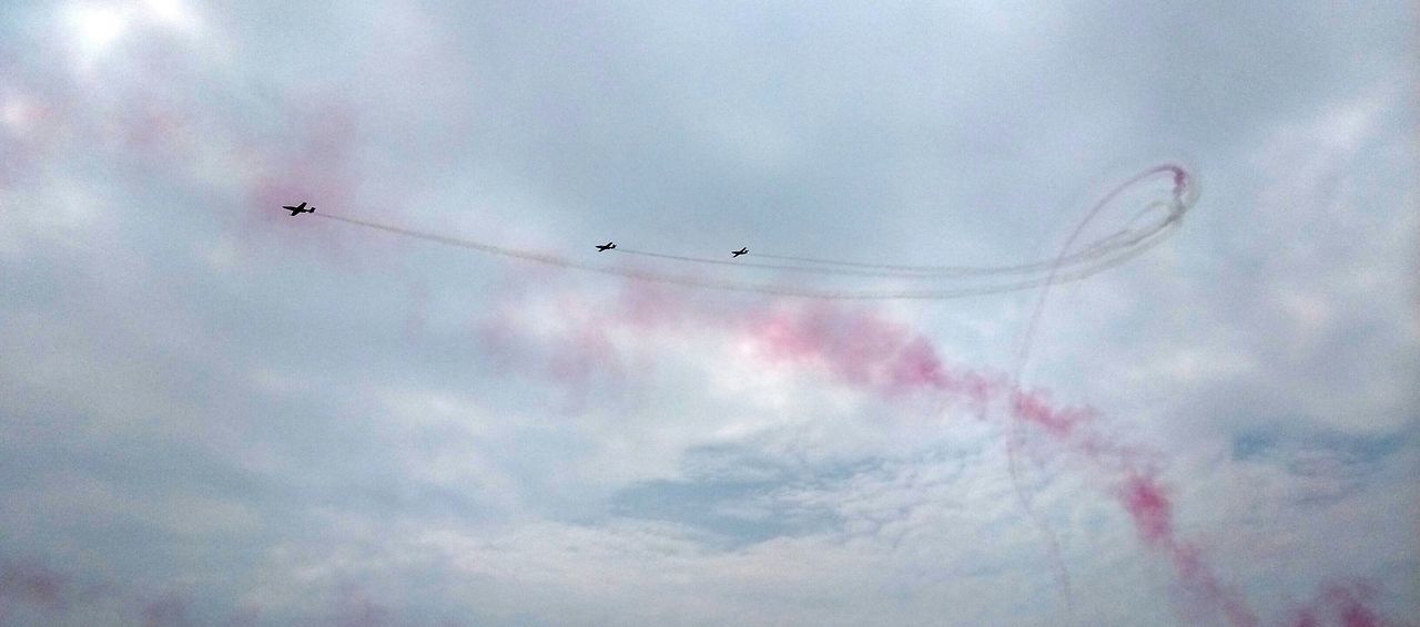 low angle view, sky, flying, cloud - sky, mid-air, airplane, transportation, air vehicle, weather, nature, cloudy, no people, beauty in nature, outdoors, cloud, mode of transport, day, dusk, motion, multi colored