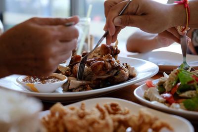 Close-up of hand holding ice cream on table