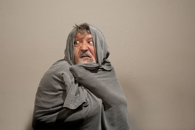 Portrait of mid adult man standing against wall