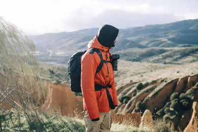 Rear view of man standing on mountain