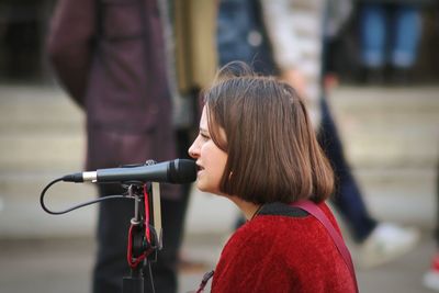 Full length portrait of a girl holding camera