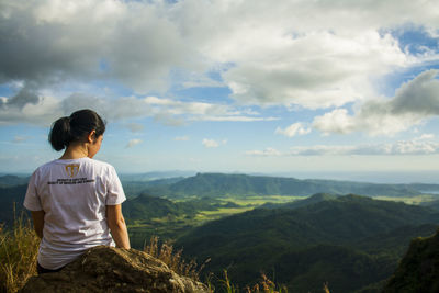 Rear view of woman looking at mountain landscape