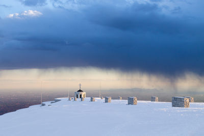 Scenic view of snow covered field against sky