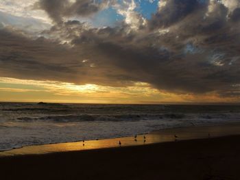 Scenic view of sea against cloudy sky