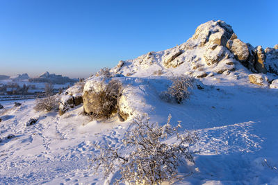 Scenic view of snowcapped mountains against clear blue sky