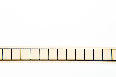 Close-up of piano against white background