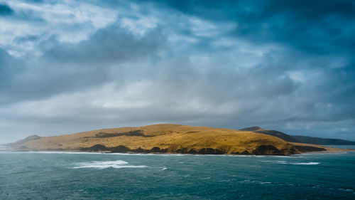 Scenic view of sea against cloudy sky