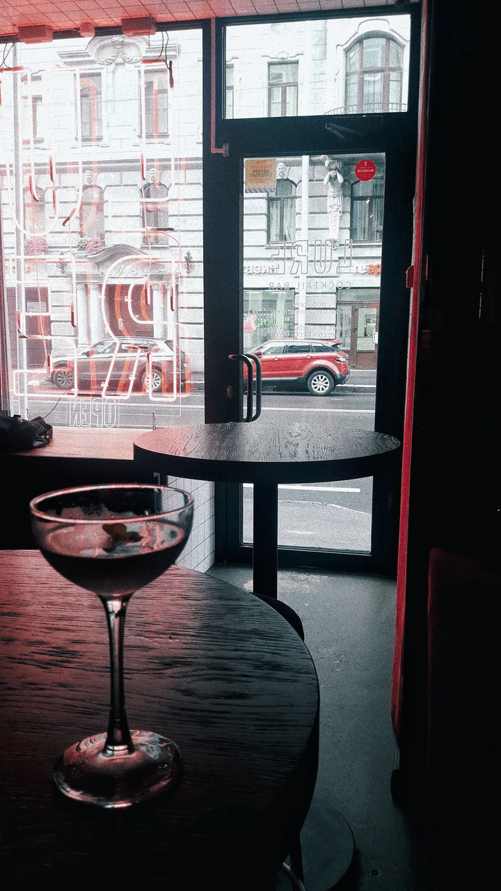 GLASS OF WINE ON TABLE AT HOME