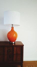 Close-up of electric lamp on table at home