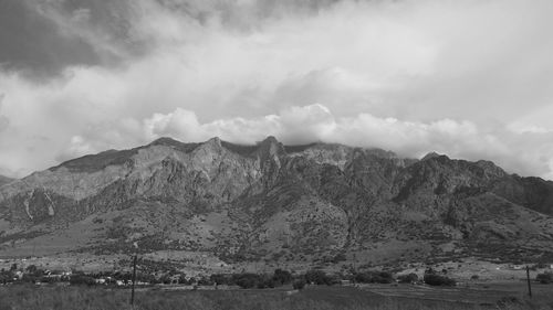 Scenic view of mountains against cloudy sky