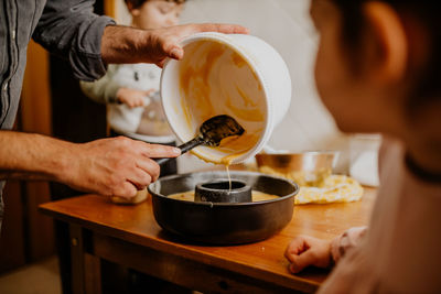 Midsection of man preparing food in kitchen