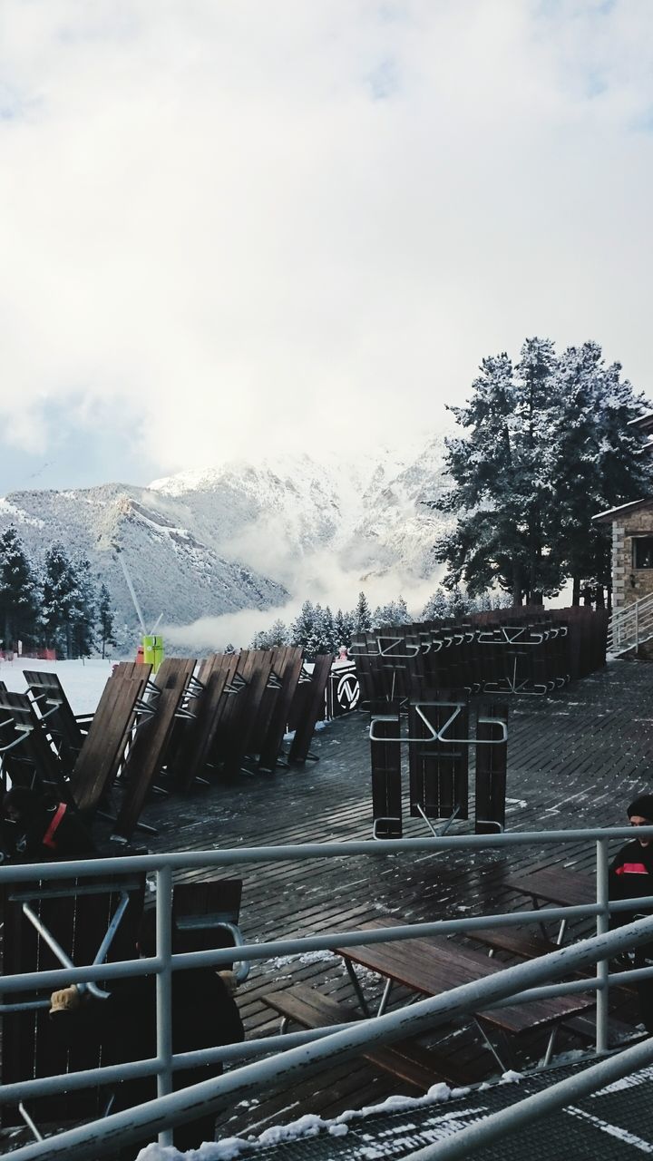 snow, winter, cold temperature, mountain, sky, weather, season, tree, built structure, railroad track, mountain range, architecture, cloud - sky, covering, nature, landscape, building exterior, tranquility, tranquil scene, snowcapped mountain