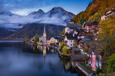 Townscape by lake at dusk