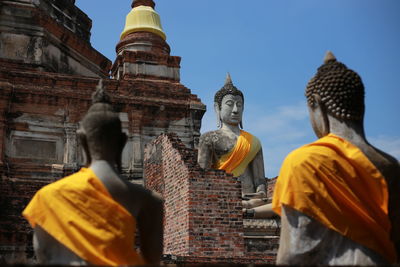 Statue of temple against building