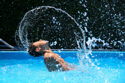 Man surfing in swimming pool