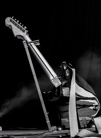 Close-up of guitar against black background