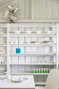 White cabin interior shelving with table setting